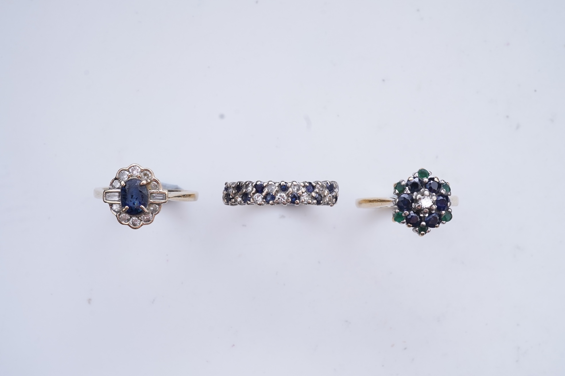 A collection of three sapphire and diamond rings